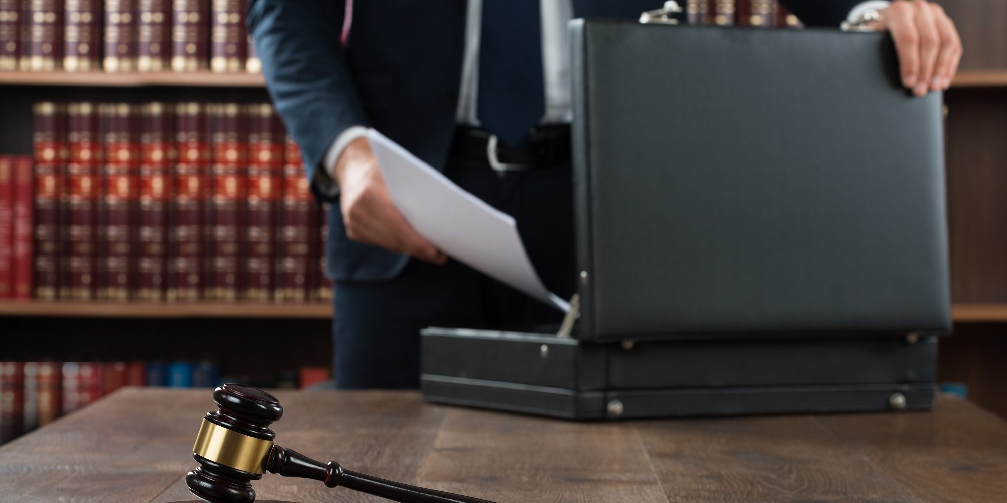 Retirement plan liability Lawyer arranging documents in retirement plan lawsuit.