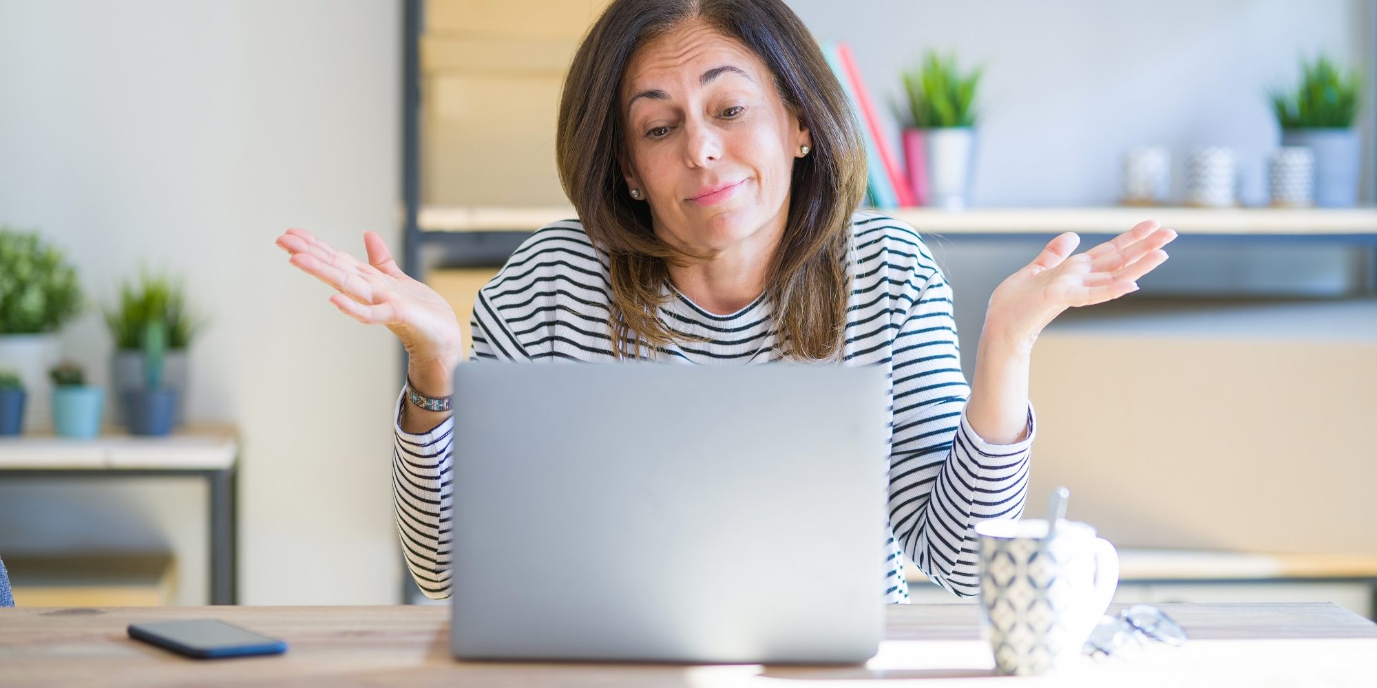 Perplexed woman considering retirement funds Perplexed woman considering retirement funds on laptop