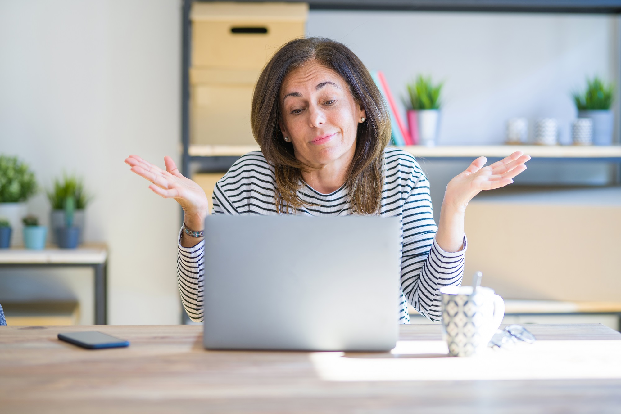 Perplexed woman considering retirement funds Perplexed woman considering retirement funds on laptop